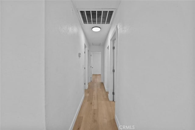 hallway with light hardwood / wood-style flooring