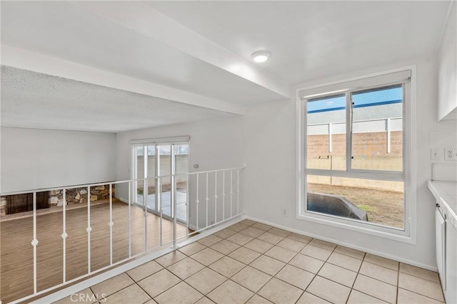 spare room with plenty of natural light and light tile patterned flooring