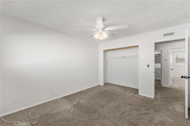 unfurnished bedroom featuring a closet, ceiling fan, a textured ceiling, and carpet floors