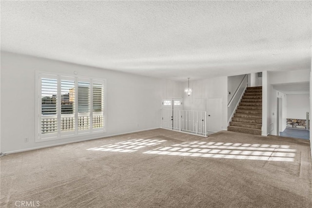 carpeted spare room featuring a textured ceiling