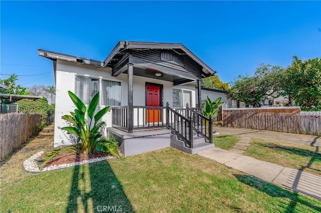 bungalow-style house with a front lawn