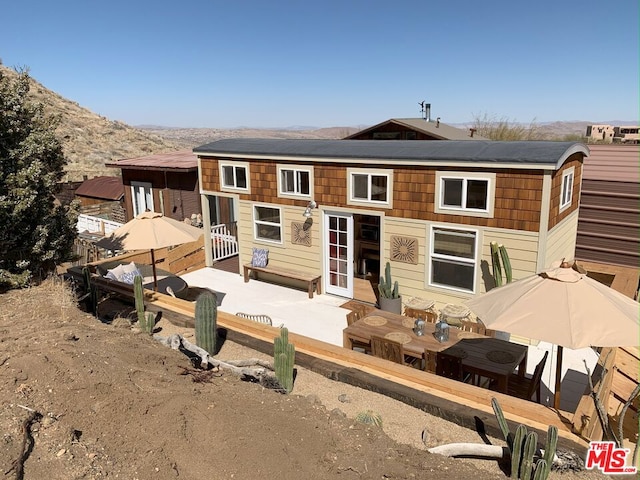 back of house with a patio area and a mountain view