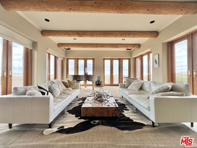 living room featuring beamed ceiling and french doors