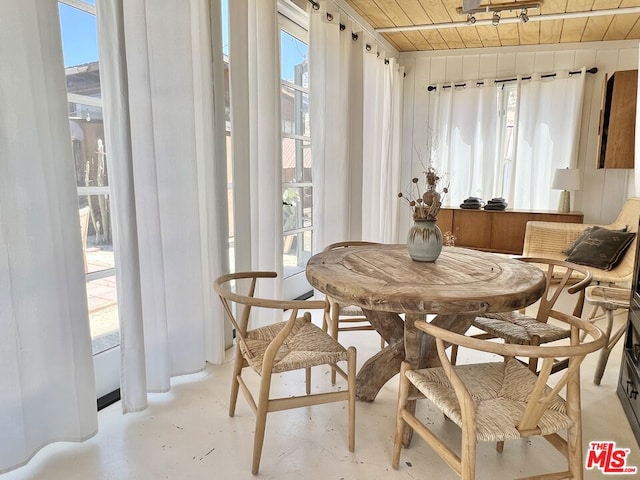 sunroom with wooden ceiling and a healthy amount of sunlight