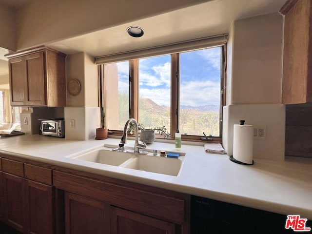 kitchen featuring a mountain view and sink