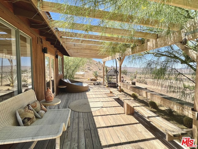 wooden deck with a mountain view and a pergola