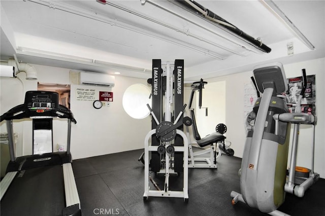 workout area featuring a wall unit AC