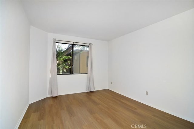 unfurnished room featuring wood-type flooring