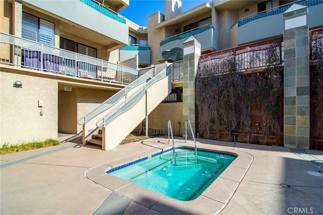 view of swimming pool with a community hot tub