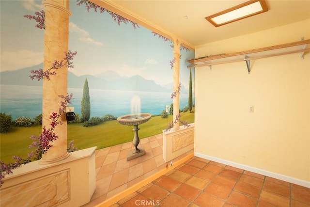 interior space featuring tile patterned flooring, a mountain view, and decorative columns