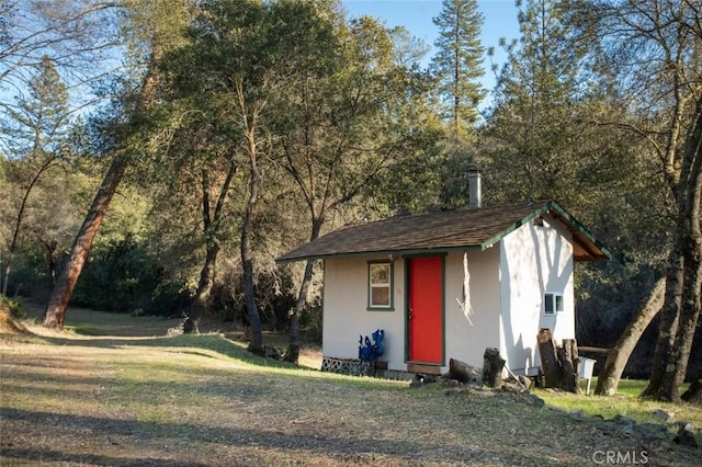 view of outbuilding with a lawn