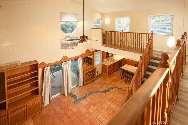 staircase featuring ceiling fan and vaulted ceiling