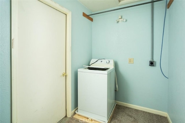 laundry area featuring washer / clothes dryer and light carpet