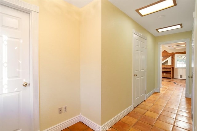 hall featuring light tile patterned floors