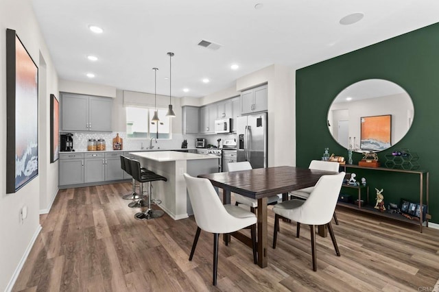 dining room featuring dark wood-type flooring and sink