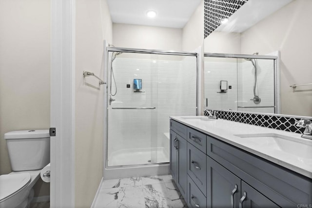 bathroom with a shower with door, toilet, and vanity