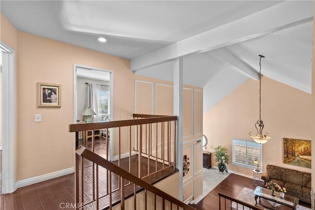 corridor with hardwood / wood-style flooring and beam ceiling