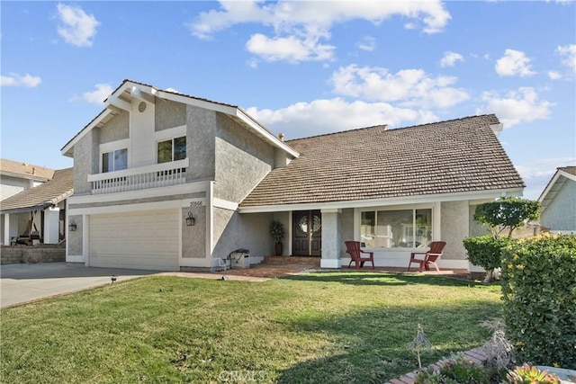 20566 Alaminos Dr, Saugus, CA 91350 - view of front of home with stucco siding, concrete driveway, covered porch, a front yard, and an attached garage