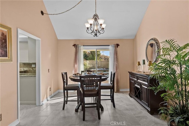 dining room with a chandelier and vaulted ceiling