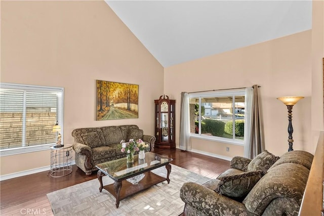 living room featuring hardwood / wood-style flooring, plenty of natural light, and high vaulted ceiling