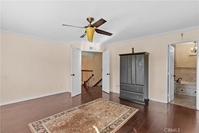 bedroom with ceiling fan with notable chandelier, ornamental molding, dark wood-type flooring, and ensuite bath