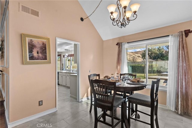 20566 Alaminos Dr, Saugus, CA 91350 - dining area with a chandelier, plenty of natural light, baseboards, high vaulted ceiling, and light tile patterned floors