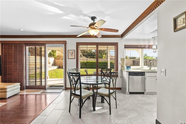 dining space with sink, ceiling fan, ornamental molding, and light tile patterned floors