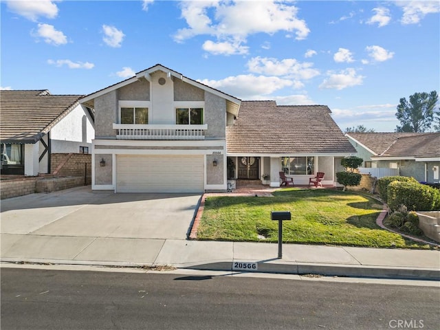 20566 Alaminos Dr, Saugus, CA 91350 - view of front facade with stucco siding, concrete driveway, a garage, and a front yard
