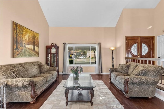 20566 Alaminos Dr, Saugus, CA 91350 - living room with high vaulted ceiling, dark wood finished floors, plenty of natural light, and baseboards
