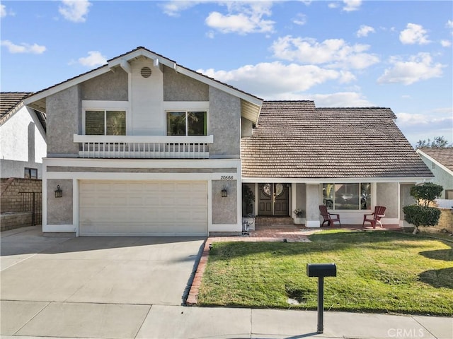 front facade featuring a garage and a front lawn