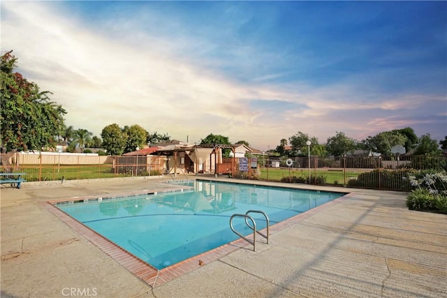 pool at dusk with a patio