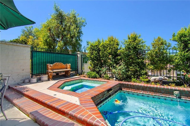 view of pool featuring an in ground hot tub