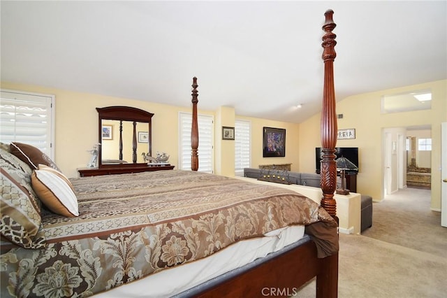 bedroom with light carpet, multiple windows, and lofted ceiling