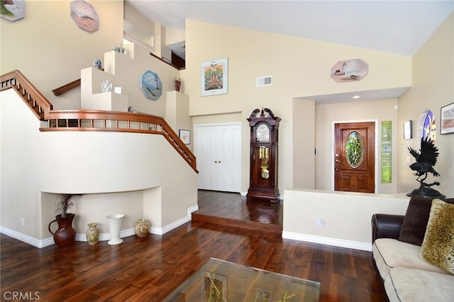 foyer featuring high vaulted ceiling and dark hardwood / wood-style flooring