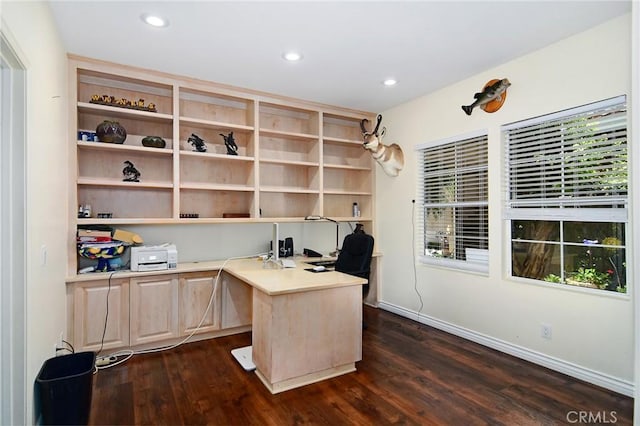 office space with dark wood-type flooring and built in desk