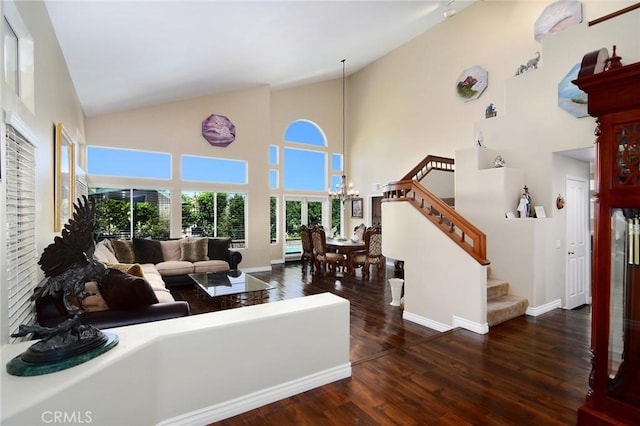 living room featuring high vaulted ceiling, dark hardwood / wood-style flooring, and a notable chandelier