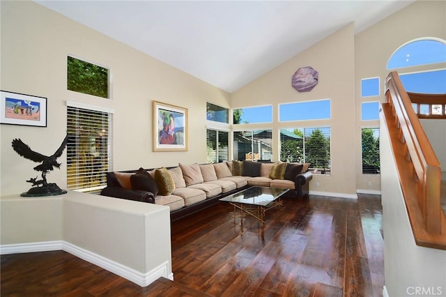 living room featuring dark wood-type flooring and high vaulted ceiling