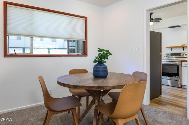 dining space featuring light colored carpet