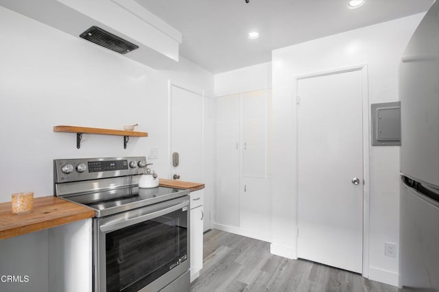 kitchen with wooden counters, light hardwood / wood-style flooring, and appliances with stainless steel finishes