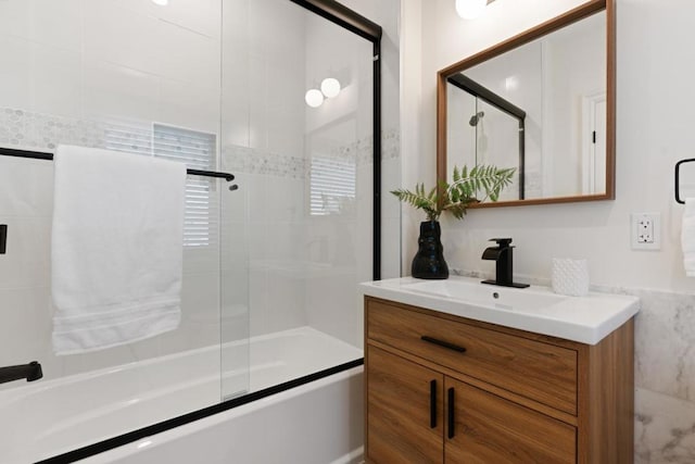 bathroom with vanity and combined bath / shower with glass door