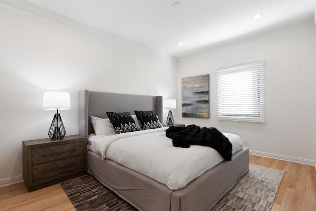 bedroom featuring wood-type flooring and ornamental molding