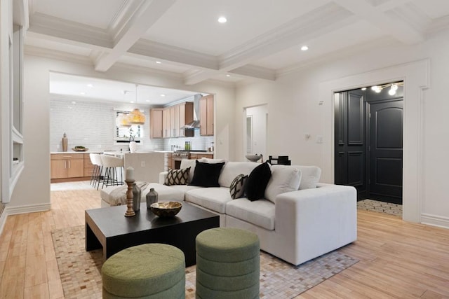 living room featuring crown molding, coffered ceiling, beam ceiling, and light hardwood / wood-style flooring