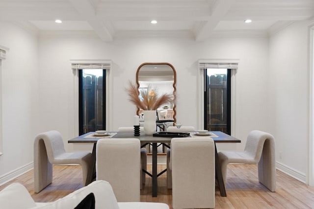 dining area featuring coffered ceiling, crown molding, light hardwood / wood-style floors, and beamed ceiling