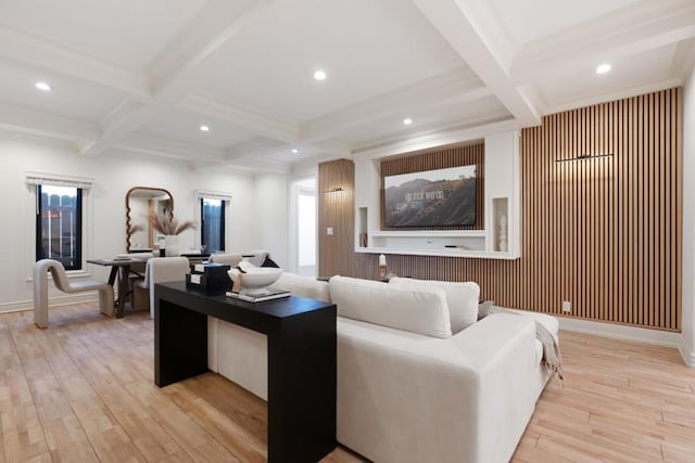 living room featuring beamed ceiling, coffered ceiling, and light hardwood / wood-style flooring