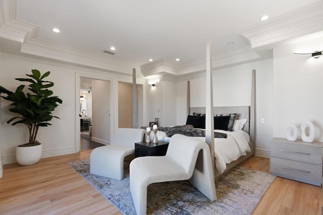 bedroom with ornamental molding and light wood-type flooring