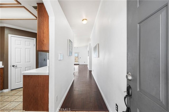 hallway featuring wood-type flooring and crown molding