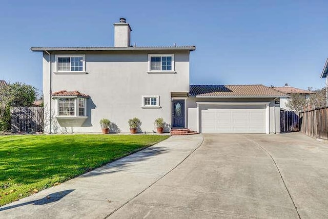 view of front facade with a garage and a front lawn