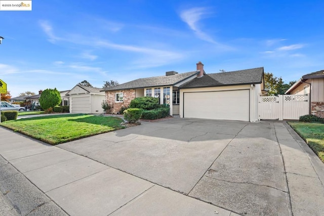 single story home featuring a garage and a front yard