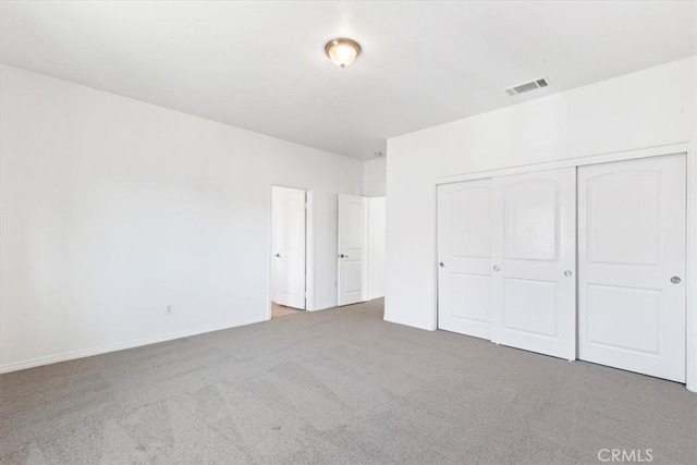 unfurnished bedroom with a closet and carpet