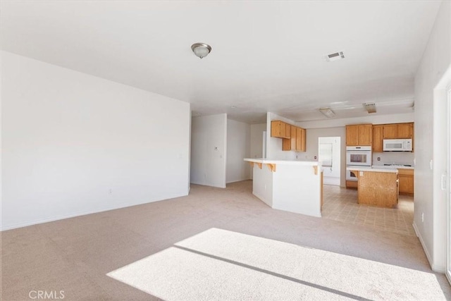 unfurnished living room with light colored carpet